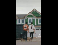 Time lapse of couple walking to their newly built house 