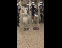 girl sits on subway turnstile pic