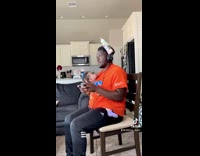 Dad with baby in shirt plays game