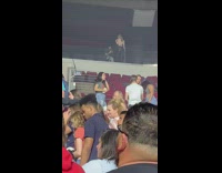 Girl poses by upper seating balcony concert