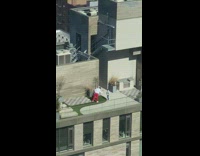Man white jacket takes picture of kid balcony