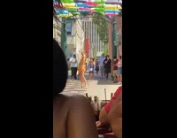 Yellow romper girl walks colorful umbrellas restaurant 
