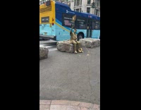 Guy covered in gold paint poses 