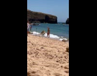Woman in bikini poses for beach video