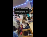 Boyfriend dances behind girlfriend taking test