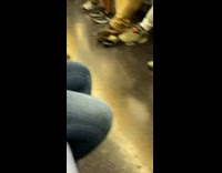 Guy rests feet on black nike sandals 