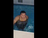 Friend pours water on girl in pool