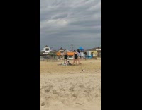 Three women bikini jump shot dance beach