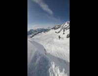 Guy rides snowmobile down cliff 
