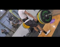 White shirt guy lifts weight indoor gym