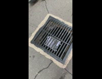 Pennywise picture taped onto the bottom side of sewer grate