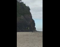Neon green bathing suit girl climbs mountain 