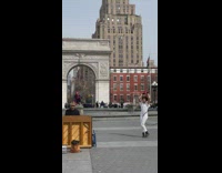 Man plays piano while woman dances with hula hoops