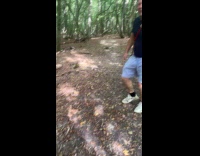 Man jump over stick carried by three dogs