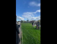 Two women tiktok dance beside the well