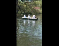 Rowboat sailed in a lake by four women in white veil and long tunics