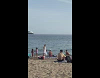 Woman in white dress spins and blows a kiss