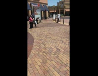Woman in white poses with luxury purse at outlets 