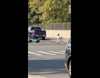 Dad rides mini car and daughter bikes along