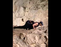 Man sleeveless top pushups behind waterfalls