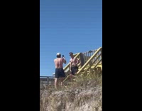 Shirtless man on stairs slap abs beach