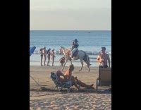 Woman in bikini sit for beach photo