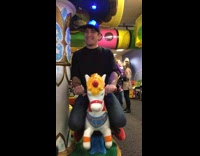 Guy rides carousel 
