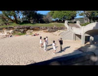 Four women white shirt beach dance video