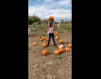 Woman beige jacket lift exercise pumpkin farm