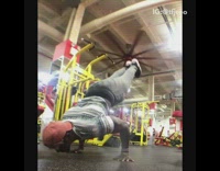Guy does handstand at indoor gym 
