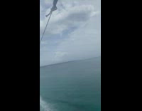 Couple get dipped into water parasailing boat stops 