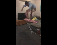 Drunk guy steps on pink ironing board and falls off, hits head on ground