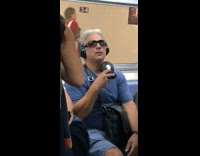 man blue shirt uses a personal fan