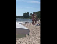 Bikini girl crawls rolls around beach 