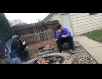 Guy purple jacket smoke stick fire pit