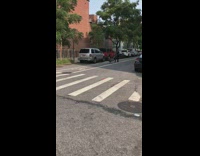 Guy drags chair down street white rope 