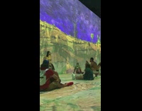 Girl yellow dress beside van gogh wall