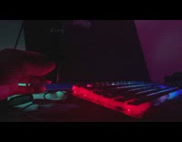 Guy blow vape on RGB keyboard slow motion