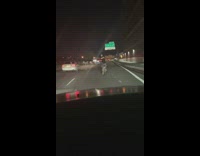 Biker Rides on the Middle of Road