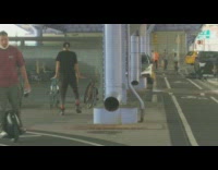 Guy dances under purple bridge parking lot 