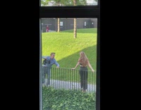 Woman in crop top poses by the railings