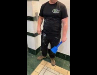 Man places plunger on head beside elevator