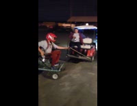 Collab SendItOfficiall - Man on trolley pulled by golfcart 