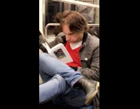 Cross Legged Man on Subway Reads Book