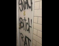 Door with graffiti message snitch bitch rat