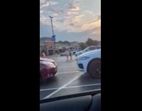 Collab IITW - Two women in green and pink top tiktok dance behind a car at the parking lot