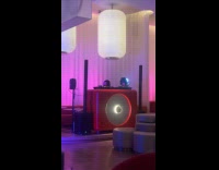 Woman selfie video with light beside DJ