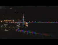 Guy looks out window at rainbow bridge 