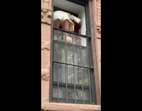 Woman climbs in through tiny crack in window over gate