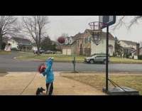 Boy does free throw while kneeling 